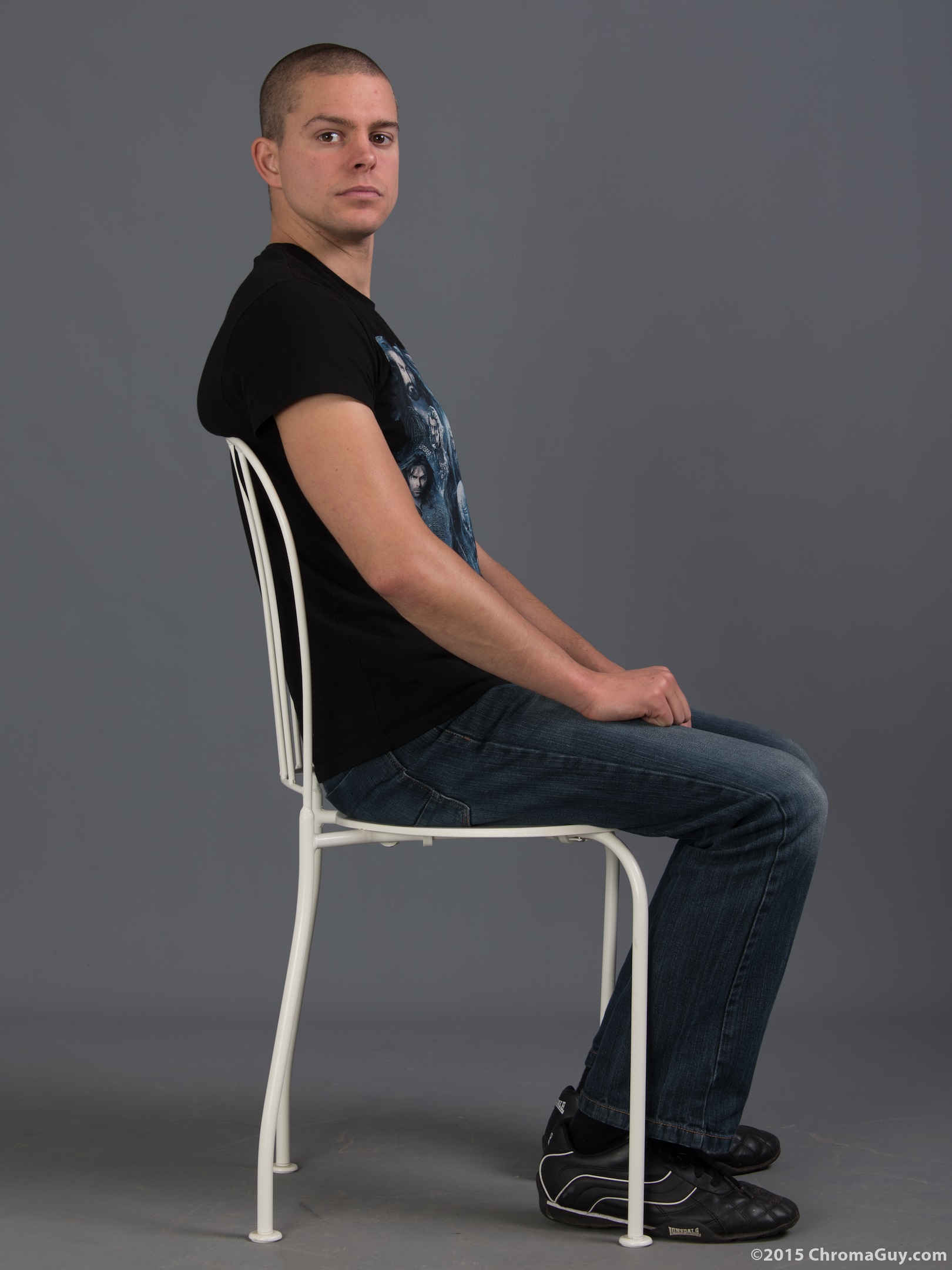 Side view of guy sitting on chair