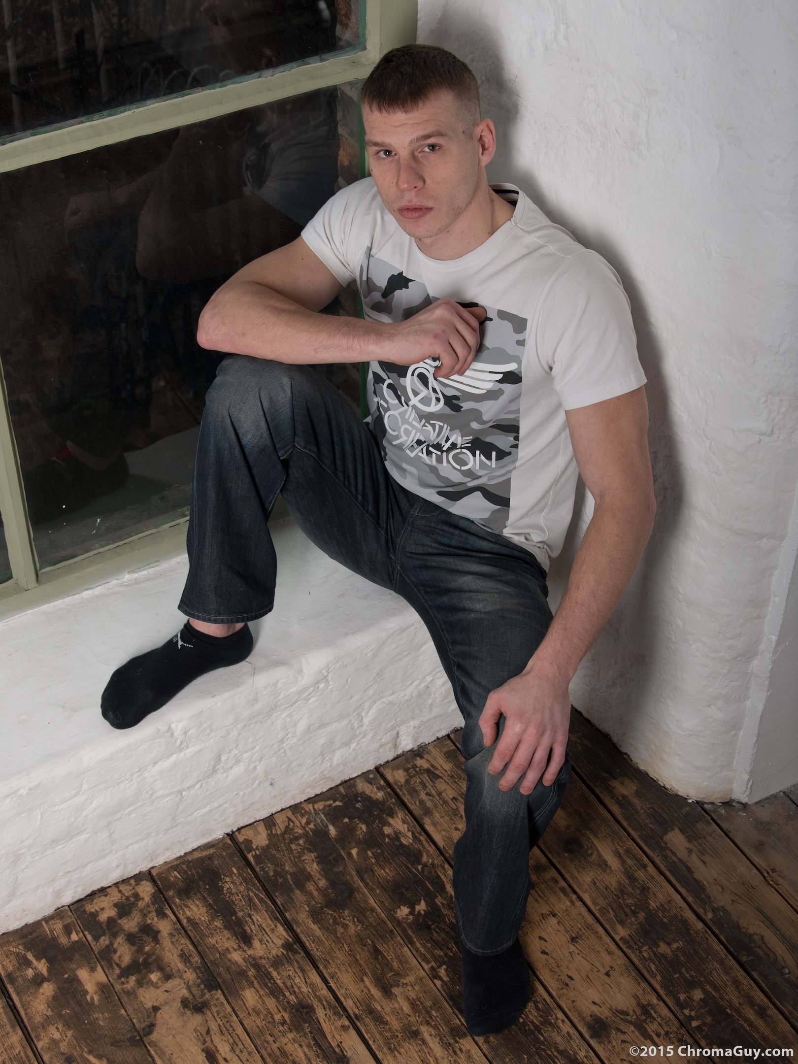 Young man sitting in jeans