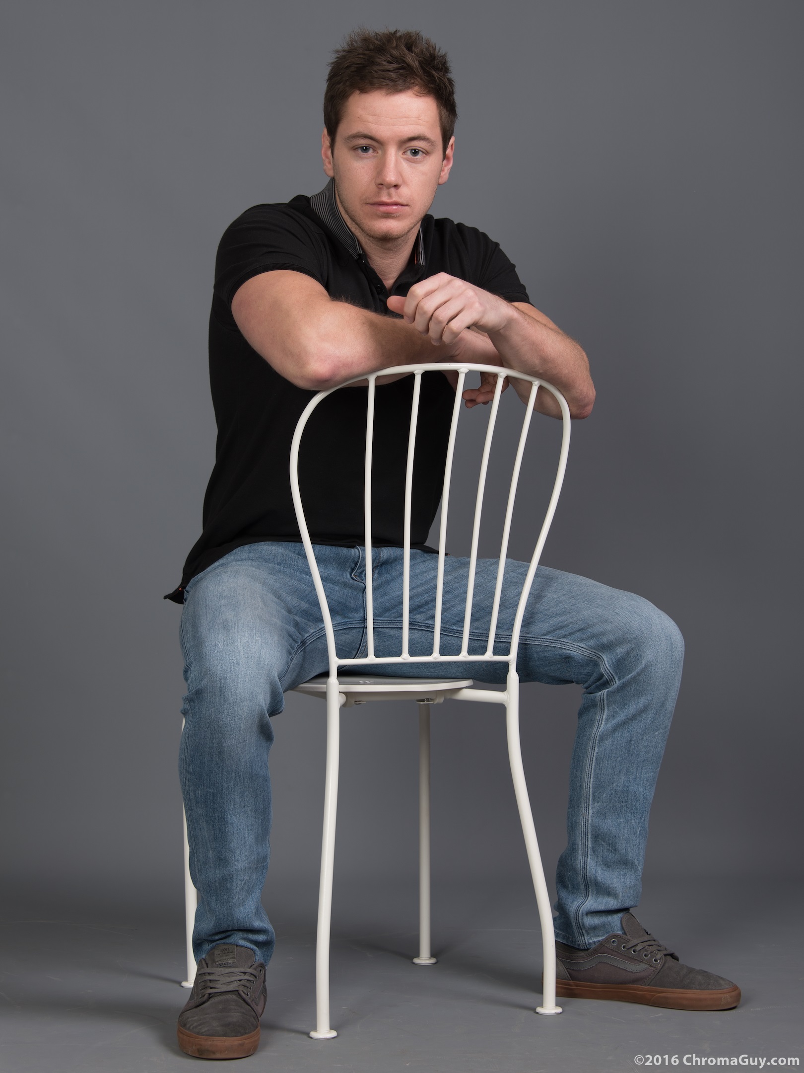 Man sitting astride chair